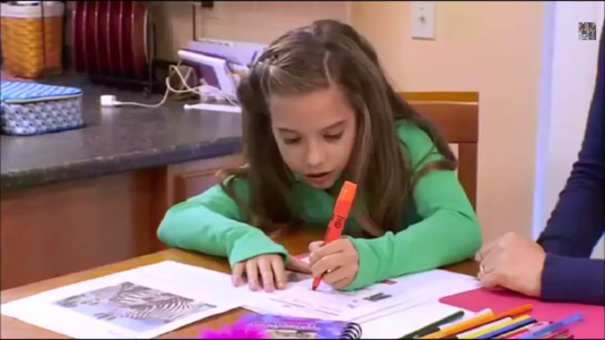 Notice the zebra printed on the piece of paper beside Maddie's sister. This isn't coincidental, there is message being communicated here through repeated symbolism. 