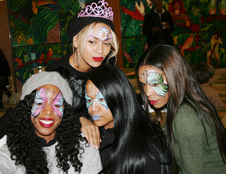 Kelly of Destiny's Child on the left joined by former band member Michelle, who also has the butterfly face paint